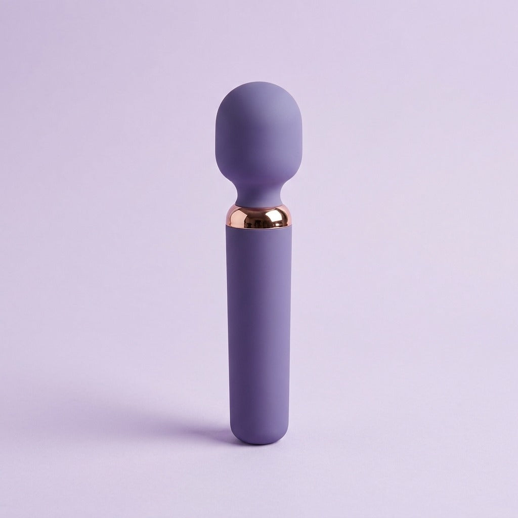 DOVIAR AURA mini wand massager with a rose-gold collar, standing on a lilac background