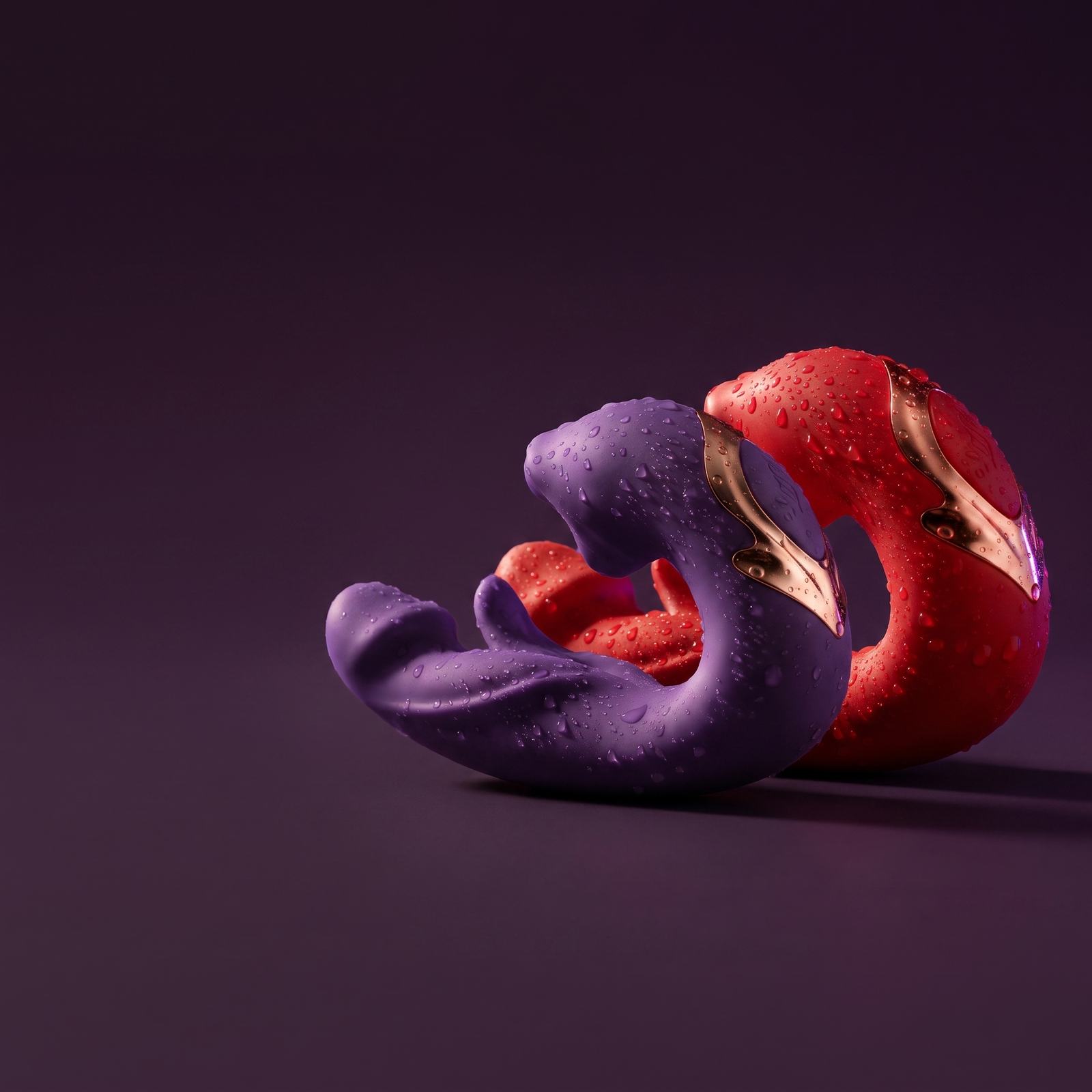 DOVIAR ÉLAN in Purple and Red together against a dark plum background