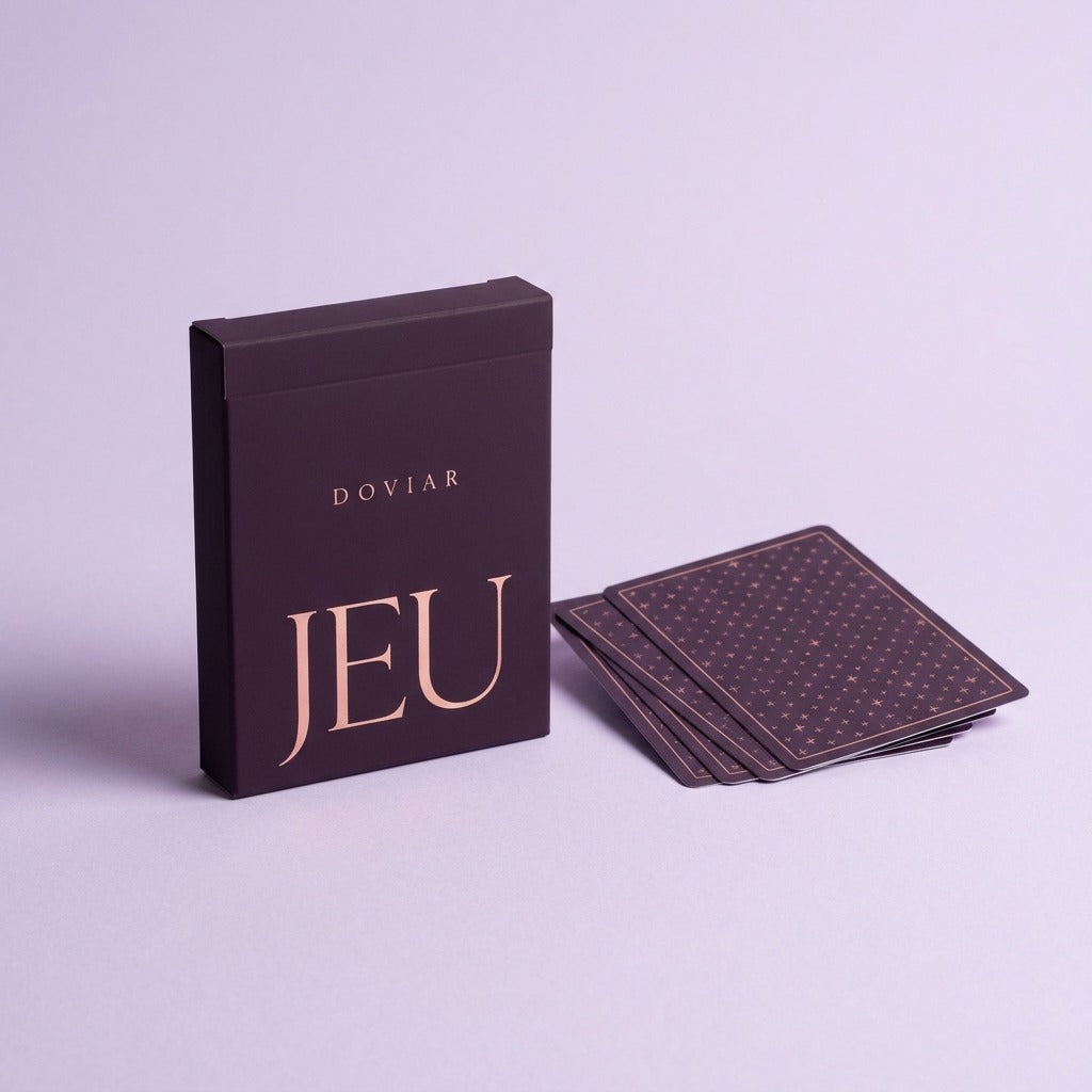 DOVIAR JEU card game box in deep plum with rose-gold lettering beside fanned cards