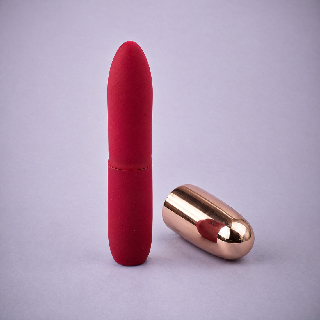 DOVIAR ROUGE lipstick vibrator on a lilac background