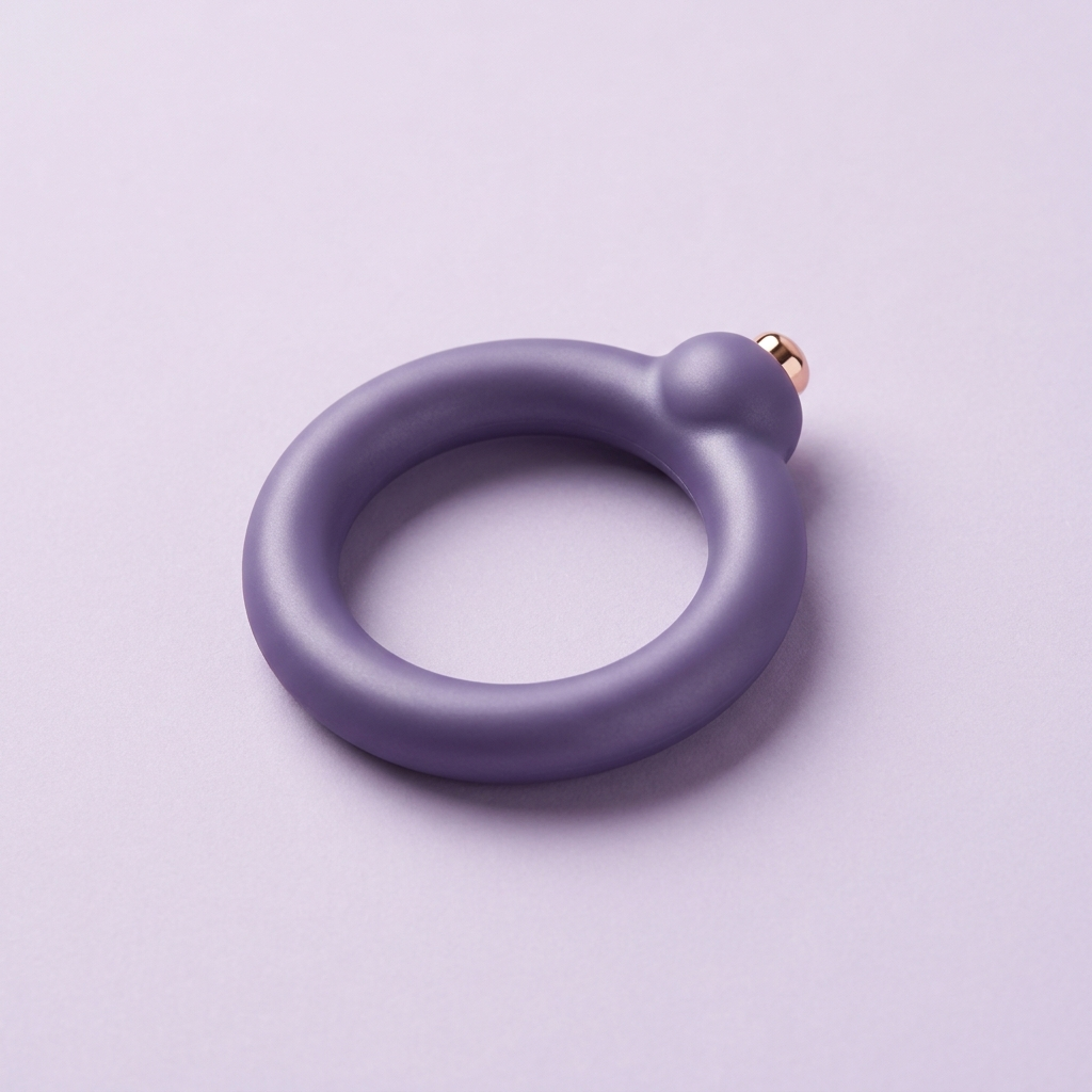 DOVIAR ORBIT flexible vibrating ring with a rose-gold button, on a lilac background